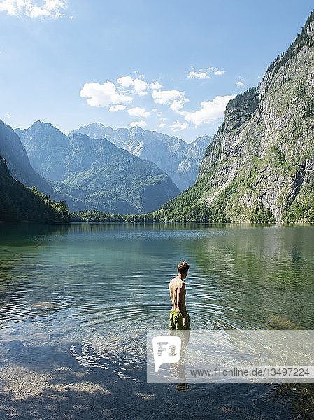 Young man bathes in lake Obersee  behind Watzmannmassiv  Salet am Königssee  Berchtesgaden National Park  Berchtesgadener Land  Upper Bavaria  Bavaria  Germany  Europe