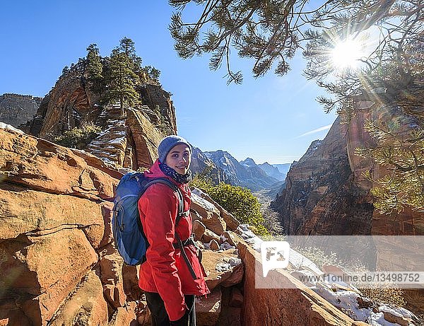 Young woman hiking on the via ferrata to Angels Landing  Angels Landing Trail  in winter  Zion Canyon  mountain landscape  Zion National Park  Utah  USA  North America