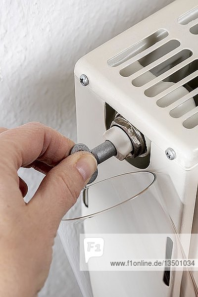 Hand venting a radiator with a special key  Bavaria  Germany  Europe