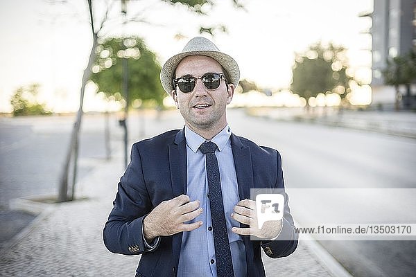 Lifestyle portrait of vintage looking man in suit with sunglasses  Poland  Europe