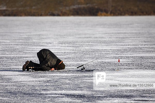 Ice fisher on a frozen lake