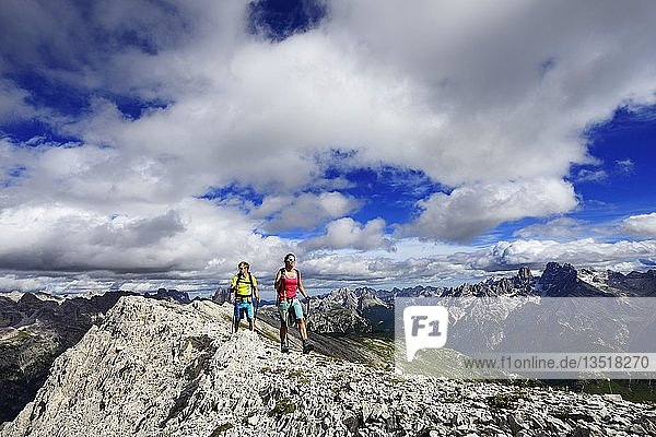 Hikers on the ascent from the Prato Piazza to the summit of the Dürrenstein  in the background Monte Cristallo and the Three Peaks of Lavaredo  Sexten Dolomites  Alta Pusteria  South Tyrol  Italy  Europe