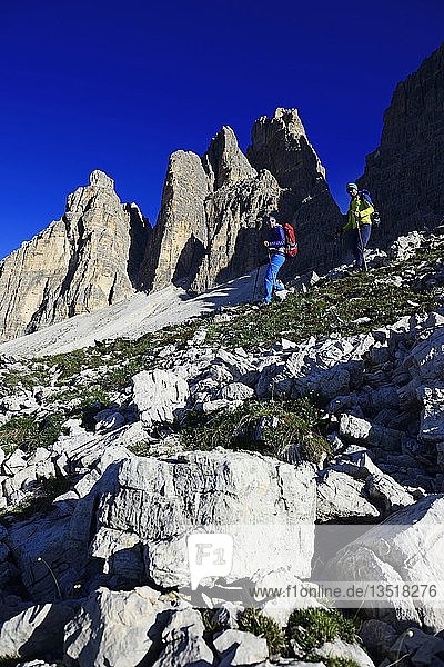 Hikers on the south side of the Three peaks of Lavaredo on the way from the Auronzo hut to the Büllele Joch hut  Sexten Dolomites  Alta Pusteria  South Tyrol  Italy  Europe