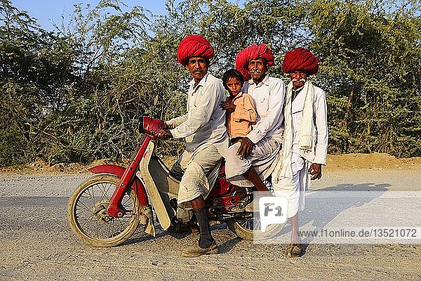 Four men from three generations riding together on a motorcycle  Rajasthan  India  Asia