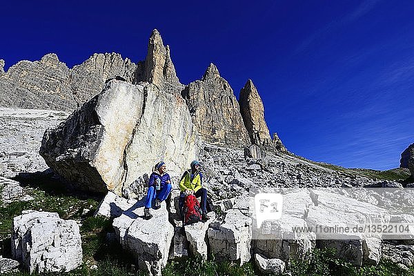 Hikers on the south side of the Three peaks of Lavaredo on the way from the Auronzo hut to the Büllele Joch hut  Sexten Dolomites  Alta Pusteria  South Tyrol  Italy  Europe