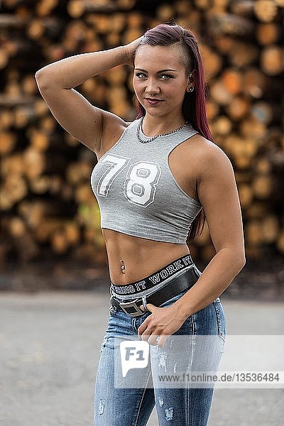 Young woman with jeans and belly top