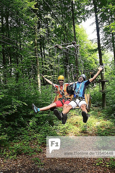Couple in the high wire park of the forest adventure center and climbing forest Riegling  Eastern Bavaria  Lower Bavaria  Bavaria  Germany  Europe