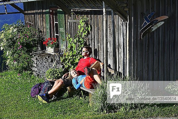 Hikers are resting in front of a hut at the Kraftalm  Itter  Kitzbühel Alps  Tyrol  Austria  Europe