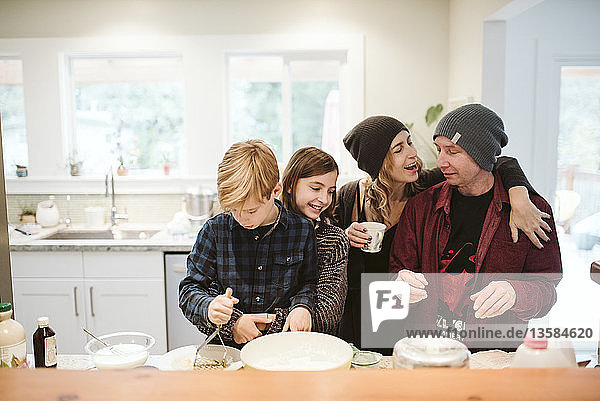 Affectionate family baking in kitchen
