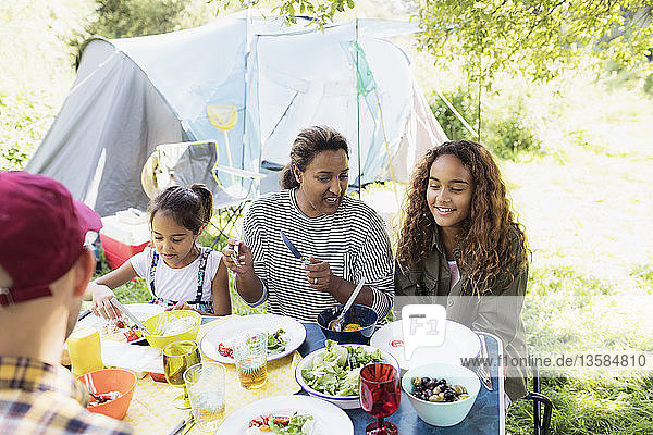 Family enjoying lunch at campsite table