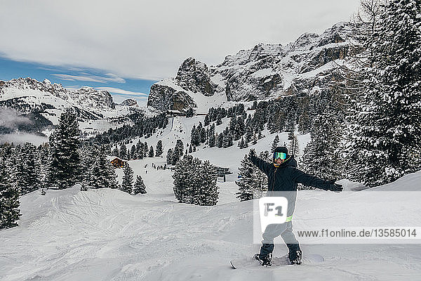 Portrait exuberant snowboarder on snowy ski slope  Dolomites  Italy
