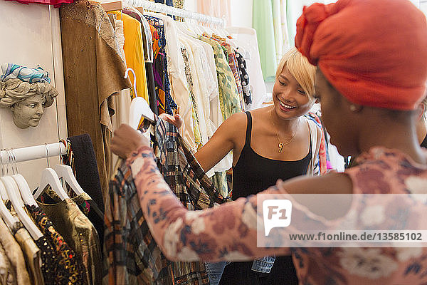 Young women friends shopping in clothing store
