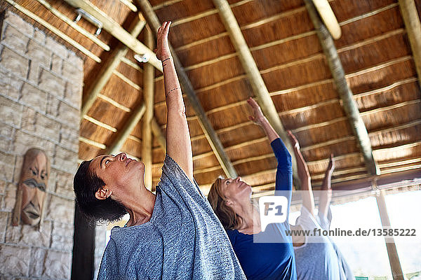 Frauen üben Yoga während eines Retreats in einer Hütte