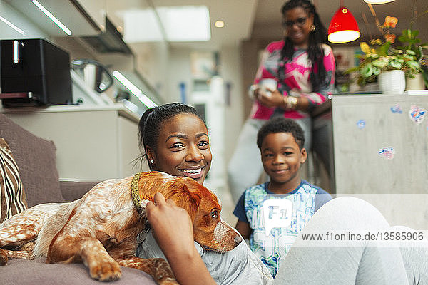 Portrait smiling family with dog at home
