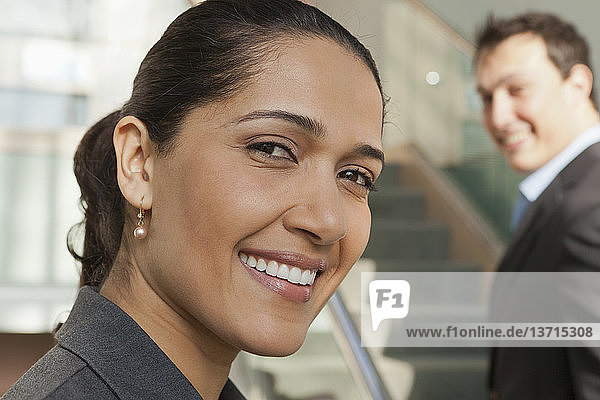 Business couple smiling in office building