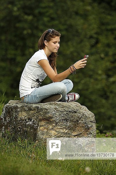Girl using an Iphone.