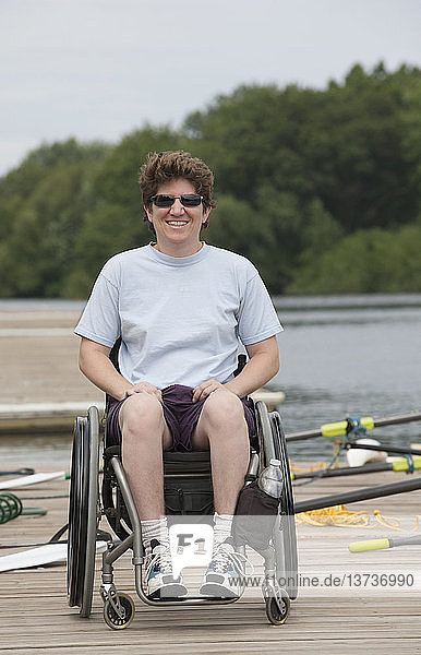 Woman with spinal cord injury sitting in a wheelchair on the dock