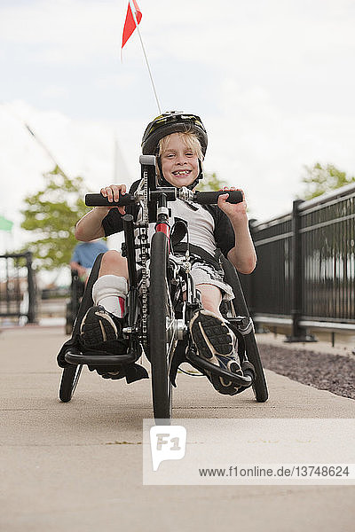 Boy with cerebral palsy in a racing bike