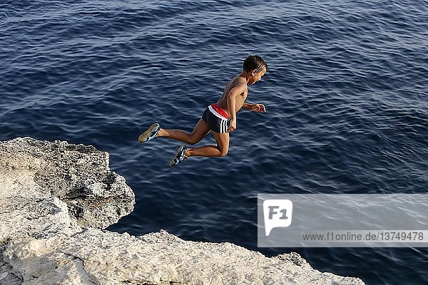 6-year-old boy jumping off a cliff.