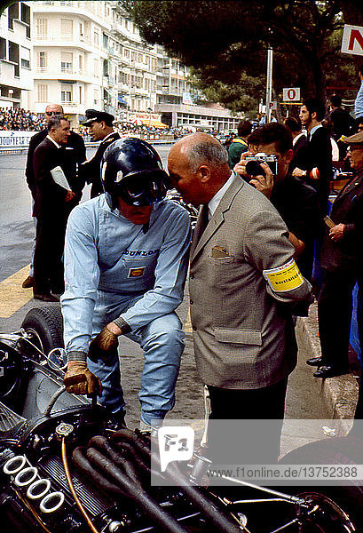 Graham Hill with his BRM P261 talks with engineer Vic Barlow of Dunlop at in the pits. Monaco Grand Prix 30 May 1965.