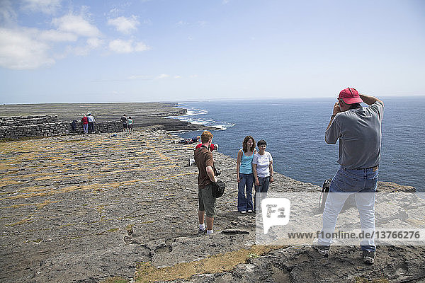 Tourists taking photos D´n Aengus fort Inishmore  Aran Islands  County Clare  Ireland