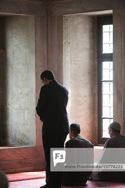 Men praying in Eyap mosque