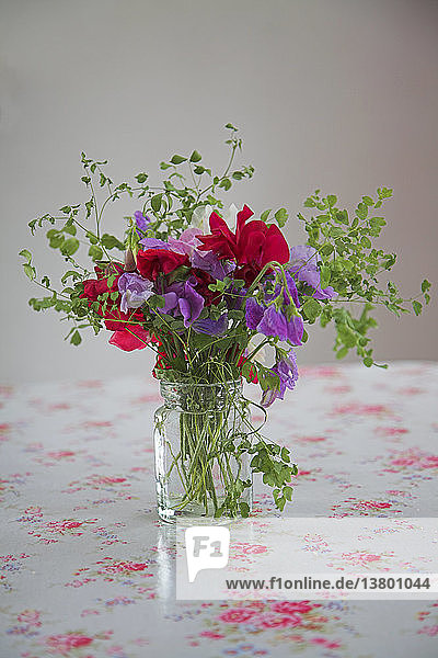 Sweet pea flowers in vase on kitchen table