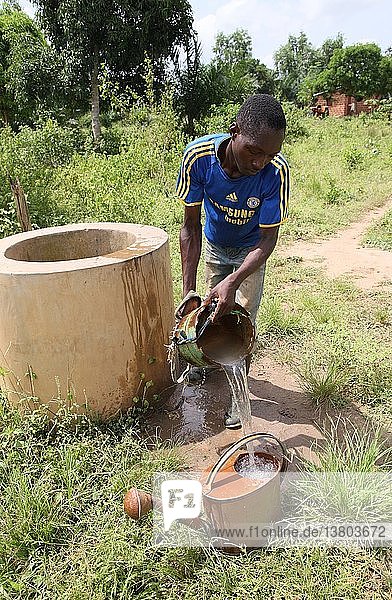 Mann holt Wasser aus einem Brunnen  Tori  Benin.