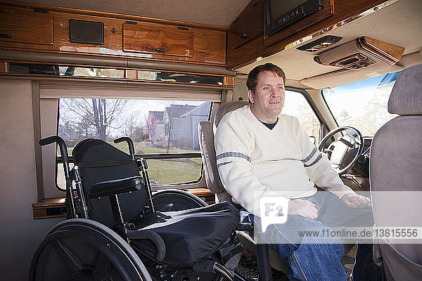Man with spinal cord injury getting into the driver´s seat from his wheelchair in accessible van