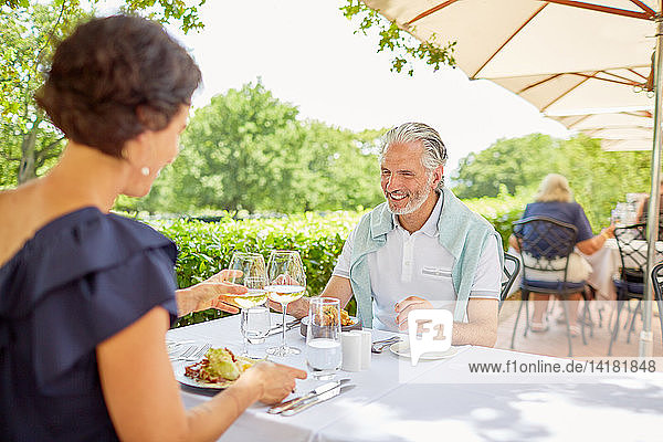 Mature couple dining at patio table