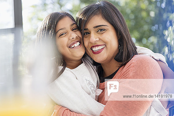 Portrait happy  confident  affectionate mother and daughter hugging