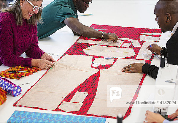 Fashion designers assembling sewing pattern