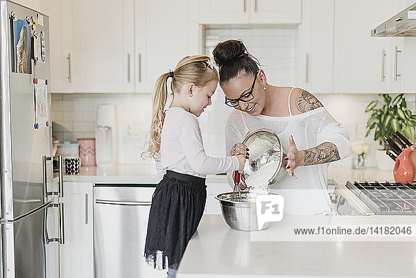 Mutter und Tochter backen in der Küche