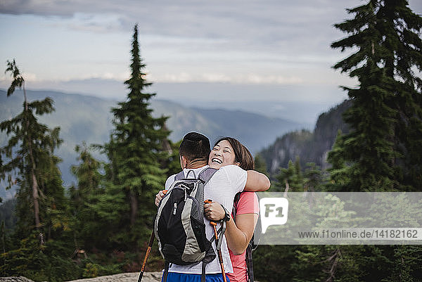Happy couple hiking  hugging on mountain  Dog Mountain  BC  Canada