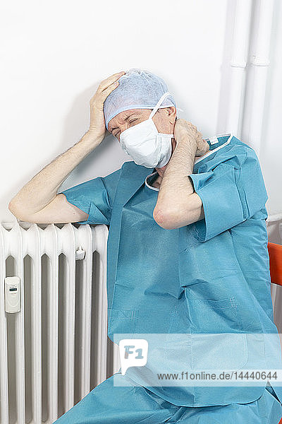 A surgeon exhausted by his work.