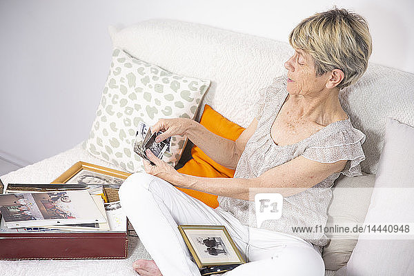 Alte Frau schaut sich Fotos an