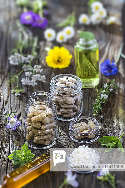 Alternative herbal medicine. herbal vitamin on ols wooden board background.