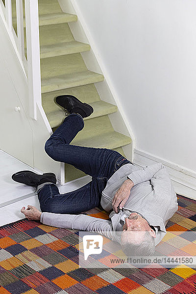 Elderly man who has fallen down stairs.