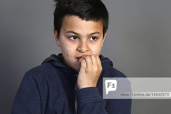 12-jähriger Junge  der an seinen Nägeln kaut. Paris  Frankreich.
