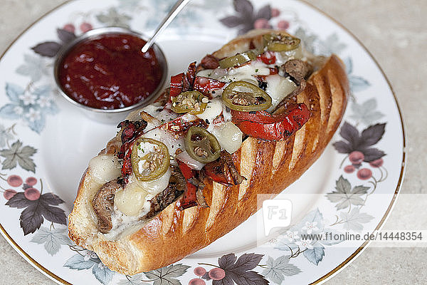 Steak mit Käse  Jalepenos und Paprika in einem Hotdog-Brötchen