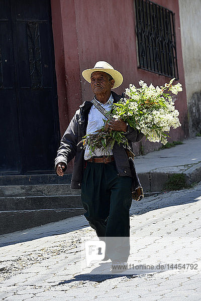 Mayan man with flowers in Chichicastenango   Guatemala  Central America.