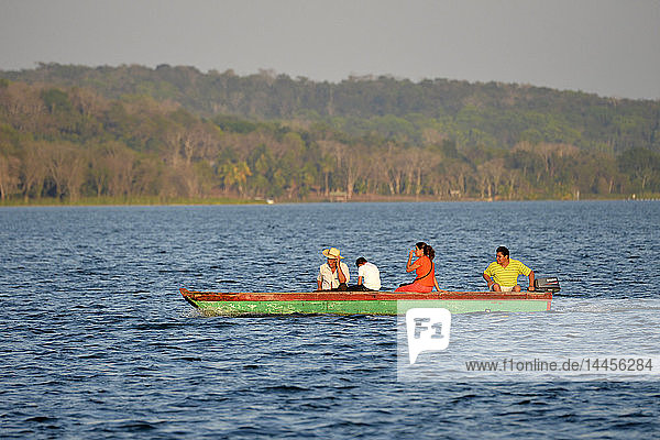 People on boat cruising Peten Itza lake in Flores  Peten  Guatemala  Central America.