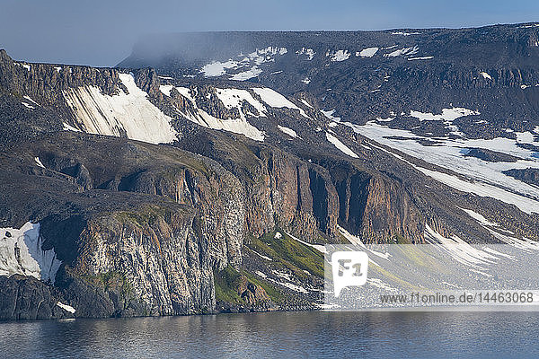 Green cliff in the glacier covered mountains of Franz Josef Land archipelago Arkhangelsk Oblast Arctic Russia