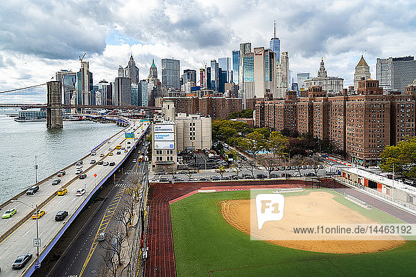 Ein Baseballfeld entlang des FDR und des East River mit Blick auf die Brooklyn Bridge und Lower Manhattan  New York  Vereinigte Staaten von Amerika  Nordamerika