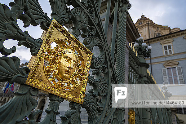 Gates of the Royal Palace of Turin (Palazzo Reale) embossed with a golden Medusa symbol  Turin  Piedmont  Italy