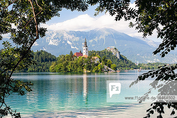 Tiny island with a church  a castle on a crag  and mountain views  Lake Bled  Slovenia