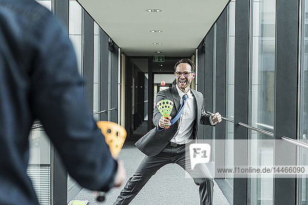 Businessman playing with colleague on the corridor