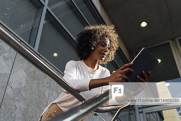Young casual businesswoman using smartphone