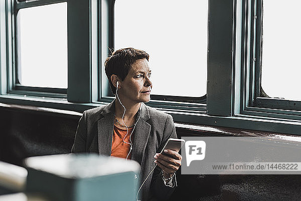 Businesswoman on a ferry looking out of window