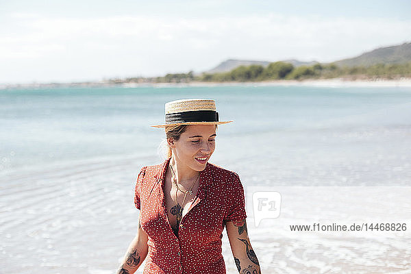 Spain  Mallorca  portrait of tattooed young woman on the beach